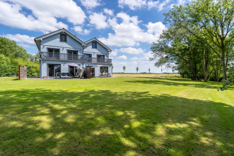 ein Haus mit einer großen Rasenfläche und Bäumen